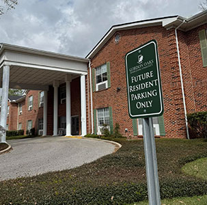 a house that has a sign on the side of a building